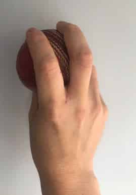 Photo showing the correct grip for an outswing delivery