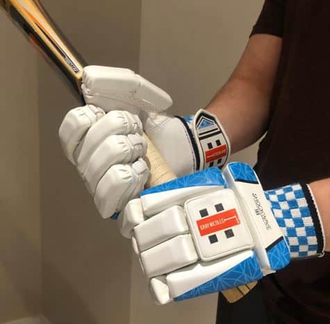 Photo Showing the bat being held in Gray-Nicolls Shockwave Gloves